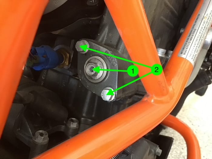 Shows steps to remove the cam chain tensioner from the engine