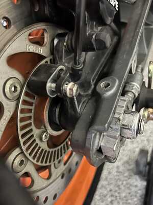 Rear wheel speed sensor in the process of being removed